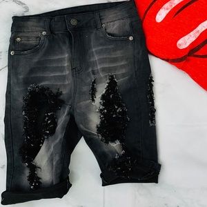 Black distressed jean shorts.